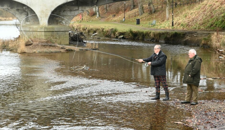 Deputy Lord Provost Ron Mckail, left, cast the first line assisted by Fred Hay from the Inverurie Angling Association.
Picture by Paul Glendell.