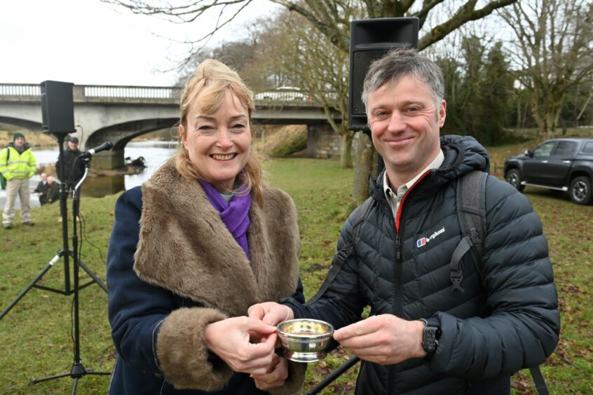 Steven Corsar, president of the Inverurie Angling Associaton and the Reverend Rona Cathcart prepairing to bless the river with a quaich of Glen Garioch whisky. Picture by Paul Glendell