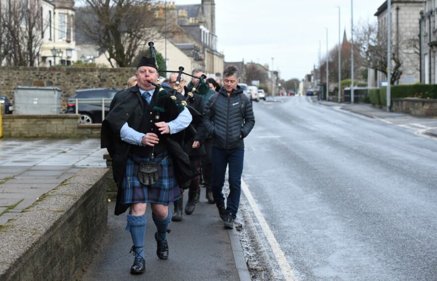 The River Don salmon opening ceremony began with piper Paul Malley leading the procession from the Kintore Arms Hotel through the streets down to the River Don. Picture by Paul Glendell.