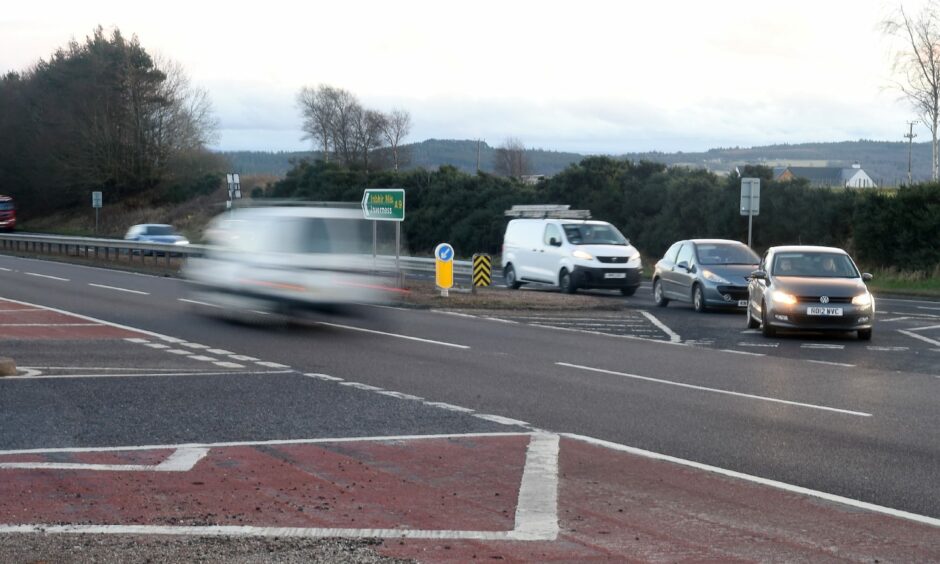 Munlochy junction right turn with cars queuing on the road.