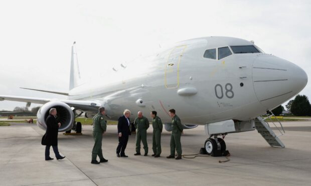 The RAF Lossiemouth Poseidon with Boris Johnson and RAF crews in front.