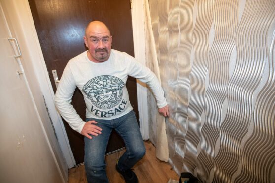 Garry Stitchell claims his council house is making him ill. Here he is showing off the damp walls. Picture: Scott Baxter