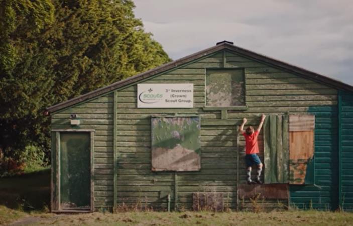 Lachlan Daguid climbing a scout group building