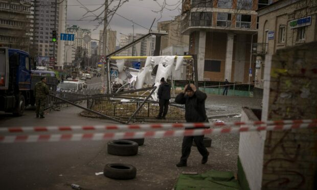 Police officers inspect area after an apparent Russian strike in Kyiv. AP Photo/Emilio Morenatti