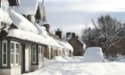 Snowy road and house in Braemar