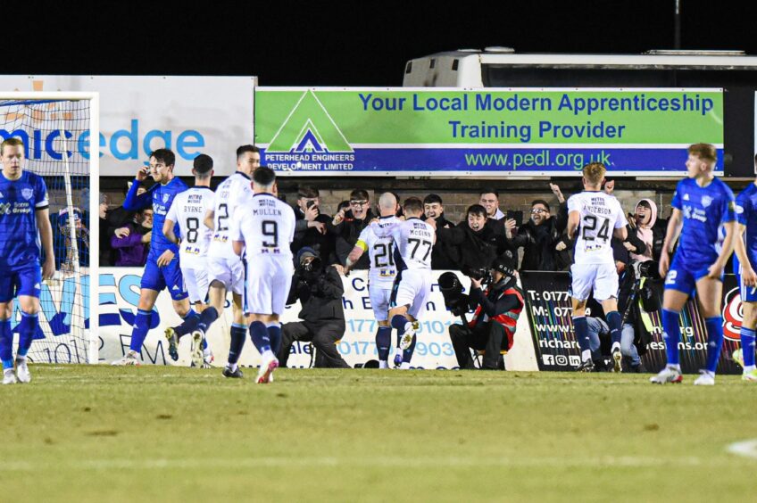 Dundee players celebrate Charlie Adam's penalty against Peterhead