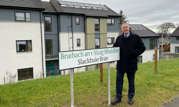 Councillor Duncan Macpherson at the new road sign for Slackbuie Brae, the road that links the housing developments behind the Asda supermarket in the Slackbuie area of Inverness South.