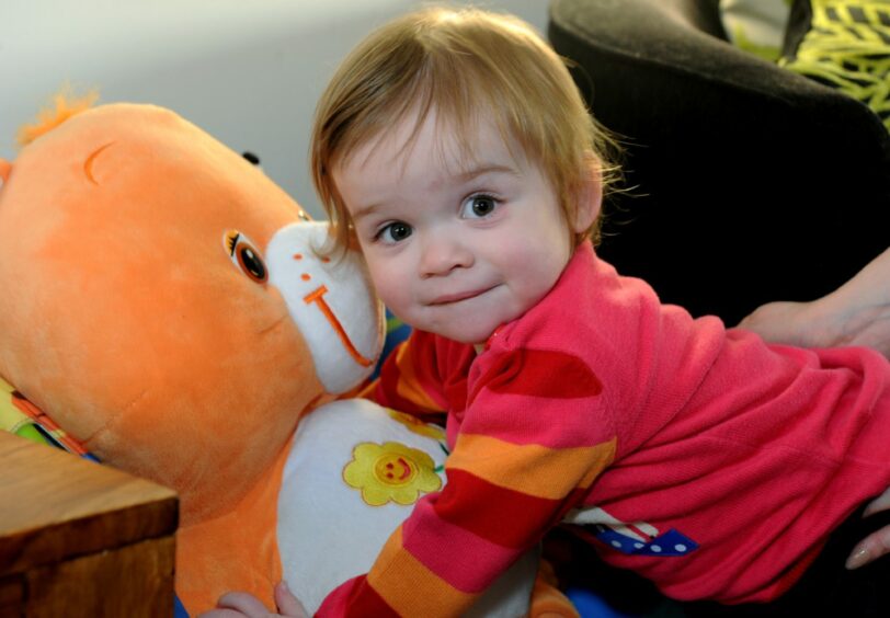 Kayleigh Cordiner cuddling teddy and giving little smile for the camera 