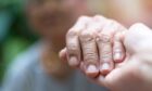 carer holding hands with client - flexible carer jobs have many benefits