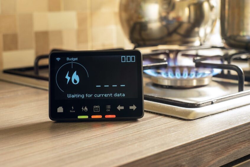 A smart meter next to a gas hob