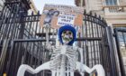 Protesters placed a skeleton 'enjoying' cheese, wine and a birthday cake outside Downing Street, while 'waiting' for Sue Gray's report (Photo: Vuk Valcic/SOPA Images/Shutterstock)