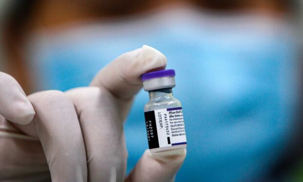 A close up view of the Pfizer Covid-19 vaccine in a vial
