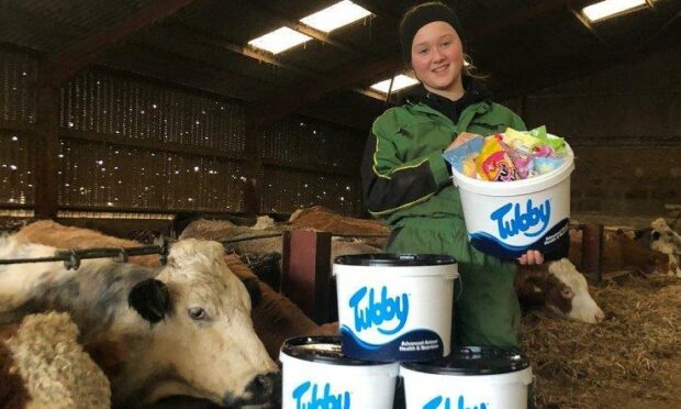 Isla Henderson with her prizes from the Tubby drawing competition.