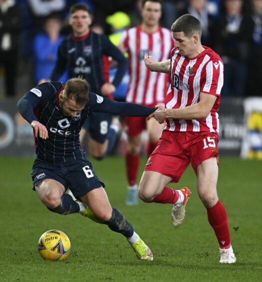 Harry Paton and Charlie Gilmour in action during a cinch Premiership match between Ross County and St. Johnstone