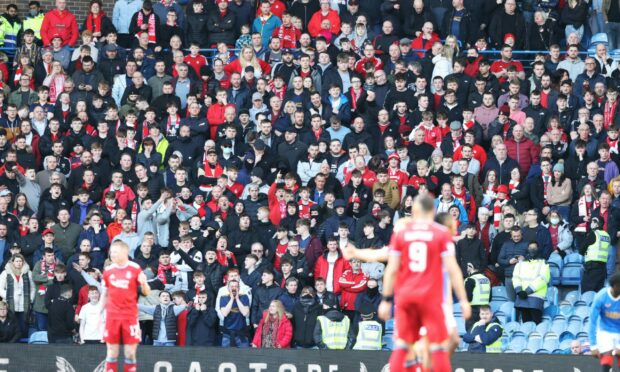 Aberdeen supporters in fine voice during the clash against Rangers at Ibrox.