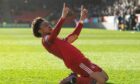 Vicente Besuijen celebrates after scoring to make it 3-1 to the Dons against Hibs.