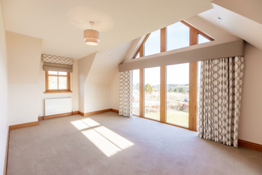 One bedroom features floor to ceiling windows