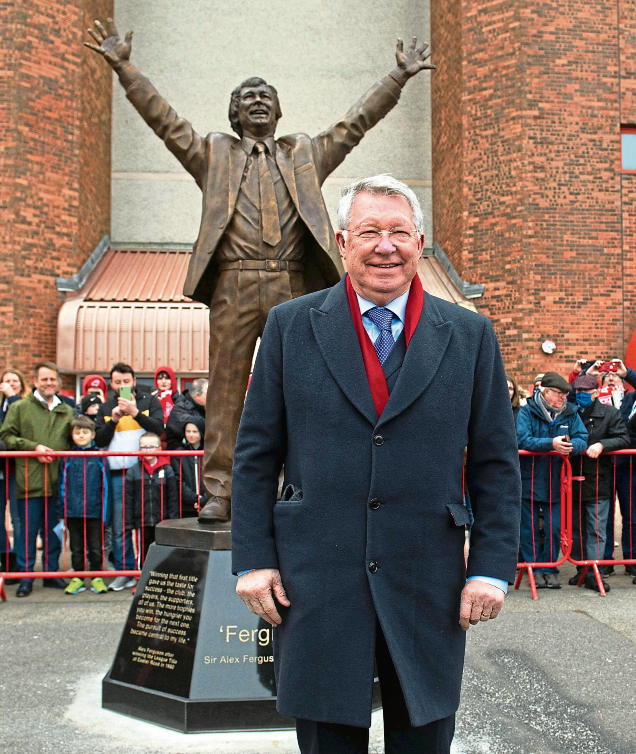 Sir Alex Ferguson with the statue in his honour in front of the Richard Donald stand at Pittodrie.