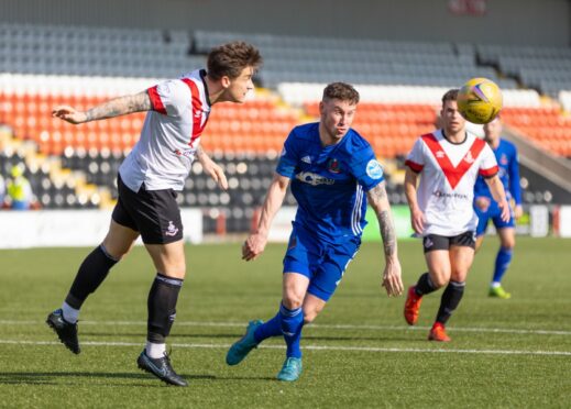 The Airdrieonians defence keep Mitch Megginson at bay