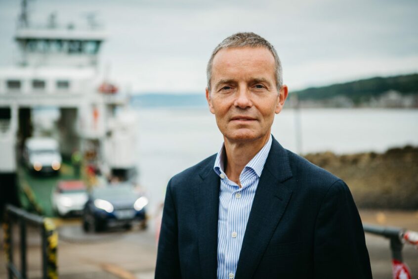 CalMac chief executive Robbie Drummond standing in front of a boat loading. 