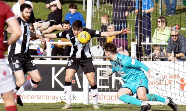 Kane O'Connor cleares the ball away from the Elgin goal.