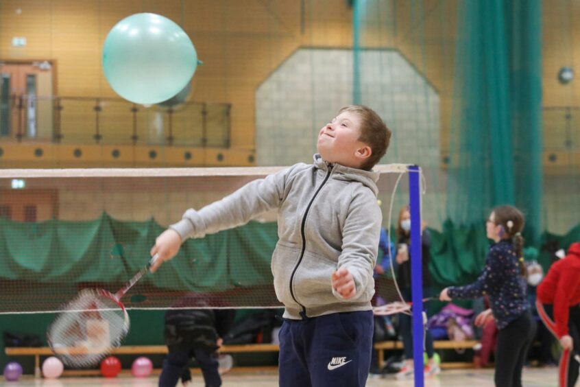 A child playing balloon badminton at the Orkney Para-sport Festival