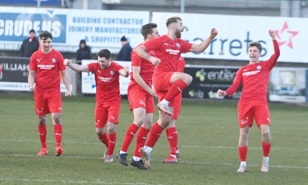 Brora Rangers players celebrate their shoot-out win.
Picture by Chris Sumner