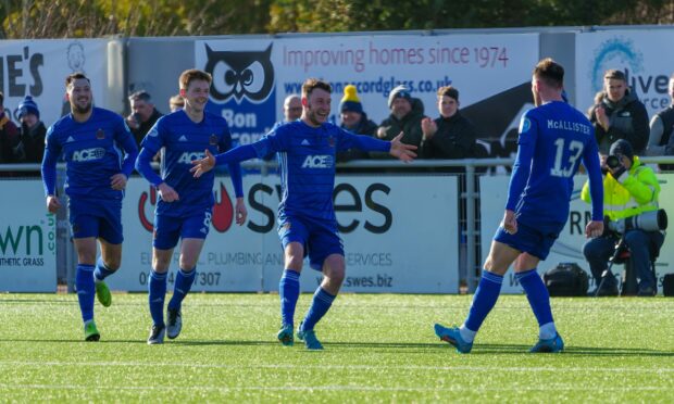 Cove Rangers captain Mitch Megginson celebrates with Rory McAllister.