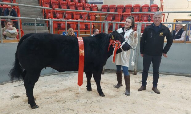 Tilly Munro with the overall champion and judge Michael Robertson.