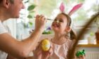 man painting child's face - activities to do in the Easter holidays