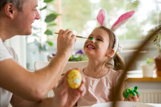 man painting child's face - activities to do in the Easter holidays