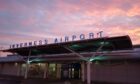 Photo of the front of Inverness Airport at sunrise