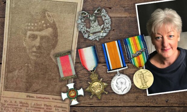 Gill Brisley, with her great-uncle's medals and a newspaper clipping about him.