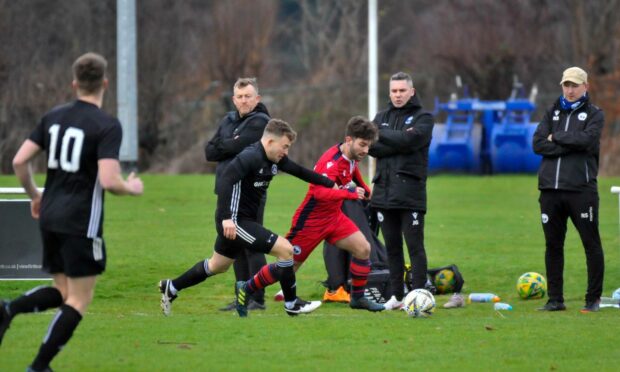 Invergordon's Niall Docherty in action against Inverness Athletic.  Pictures by SWPhoto/Stuart Wilson