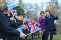 Princess Anne meets a line of flag-waving students at Gordonstoun