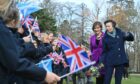 Princess Anne meets a line of flag-waving students at Gordonstoun