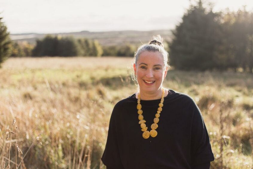 Jade Gordon standing in a field smiling