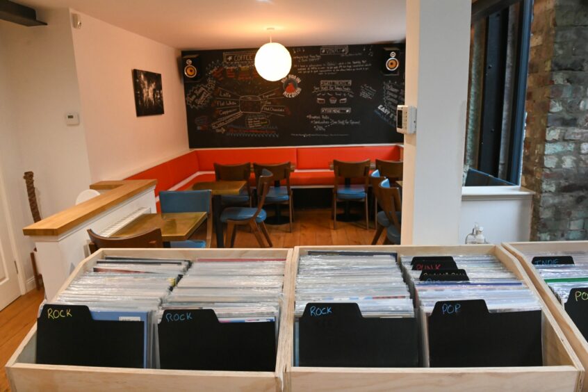 Interior of Red Robin Records in Aberdeen with view of seating a shelves of vinyl records.