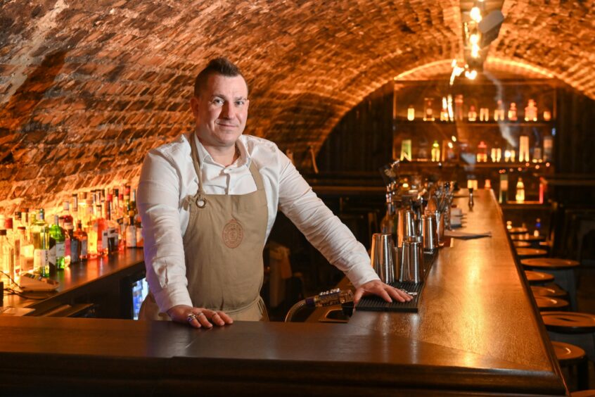 Milo Smith, of The Old Workshop, behind his bar