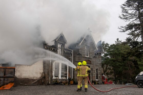 Firefighters dousing the flames at the Braemar Lodge Hotel. Picture by Kath Flannery