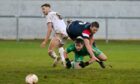Nairn's goalkeeper Dylan MacLean challenges Turriff's Matthew McDonald.