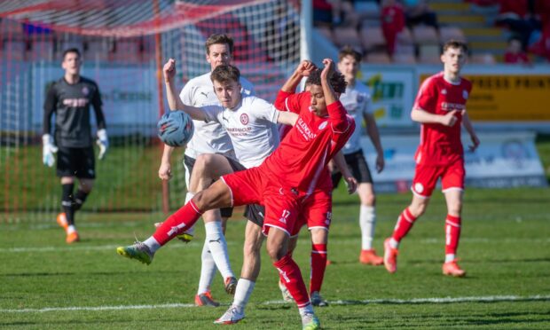 Brora's Gregor MacDonald, left, battles for possession with Seth Patrick of Brechin