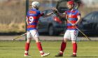 Kingussie captain Savio Genini (right) is first to congratulate Ruaridh Anderson on his opening goal against Kilmallie.