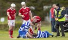 Players and officials attend the injured Iain Robinson (Newtonmore).  Kinlochshiel v Newtonmore in the opening fixture of the MOWI Premiership 2022.  Game played at Rearaig, Balmacara.; b3304206-762d-4941-a2c9-6be90748d8a8