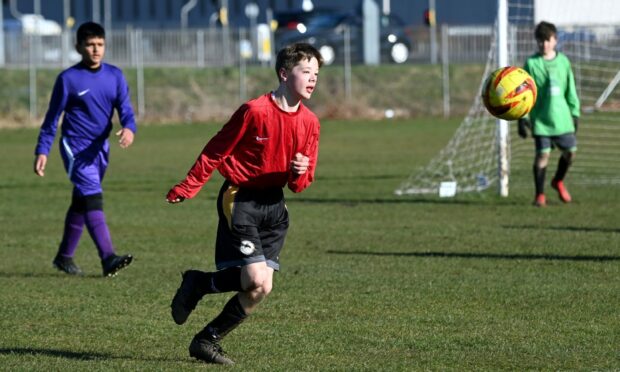 St Machar (purple) First Year v Grammar (red) First Year
Grammar's Charlie Dalziel.   
Picture by Kami Thomson