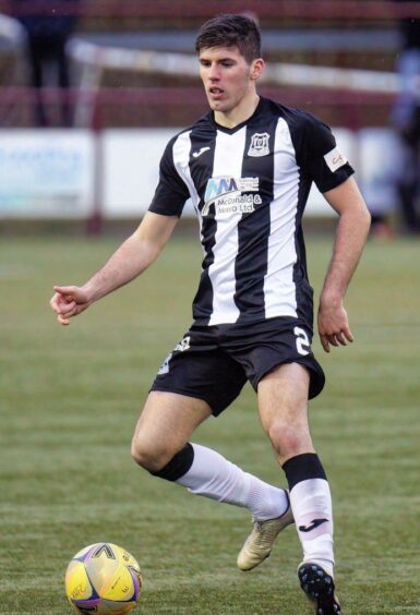 Kane O'Connor in Elgin City uniform about to kick the football 