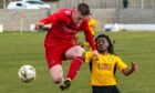 Lossiemouth's James Leslie, left, takes the ball away from Sean Muchenje of Fort William