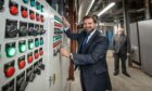 Councillor John Wheeler switches on the new power supply, along with Aberdeen Heat & Power chairman Ramsay Milne at Tillydrone Energy Centre. Image: Supplied
