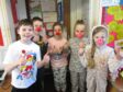 Five primary school age children wearing red noses for Comic Relief