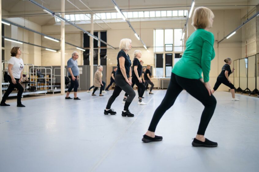 A mix of ladies and a man taking a lesson in the dance studio
